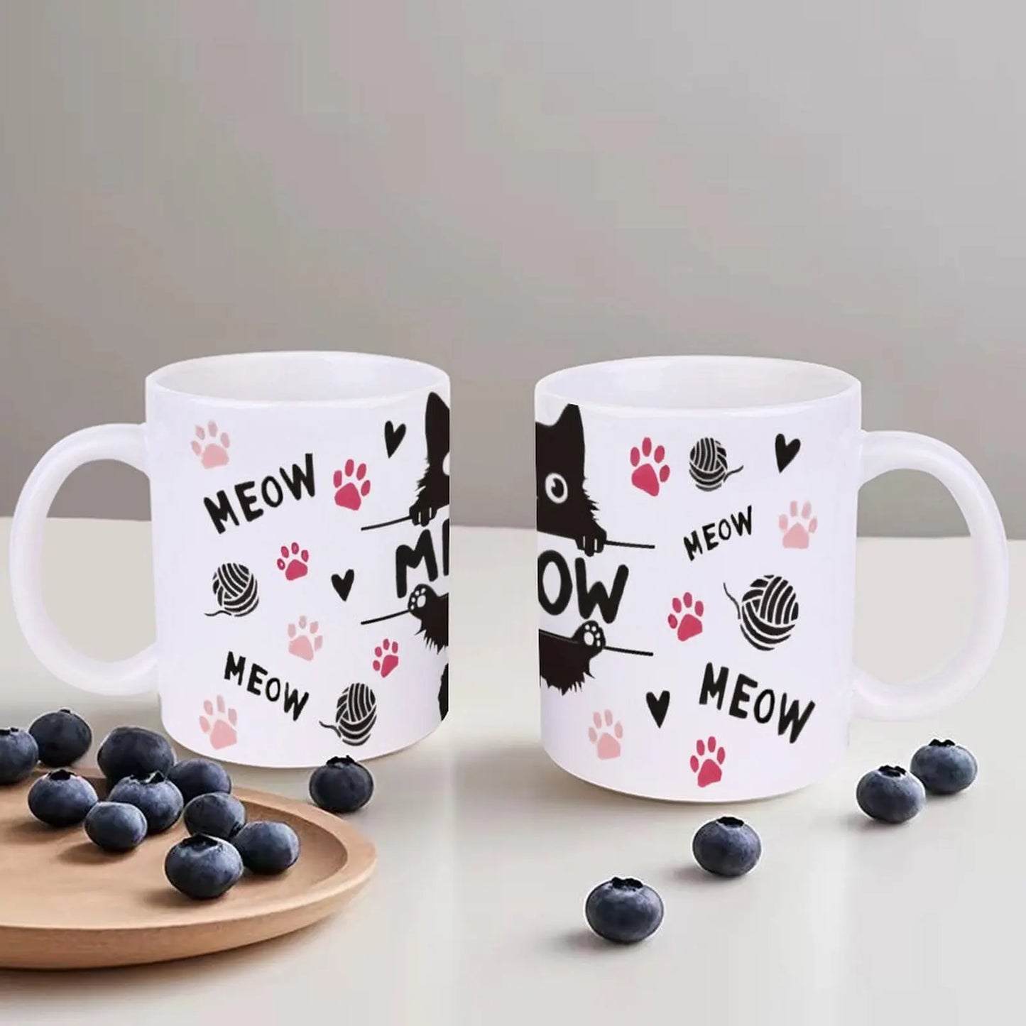 Black Cat Sitting On Top Of A Bar With Paw Prints And The Word Meow Cup